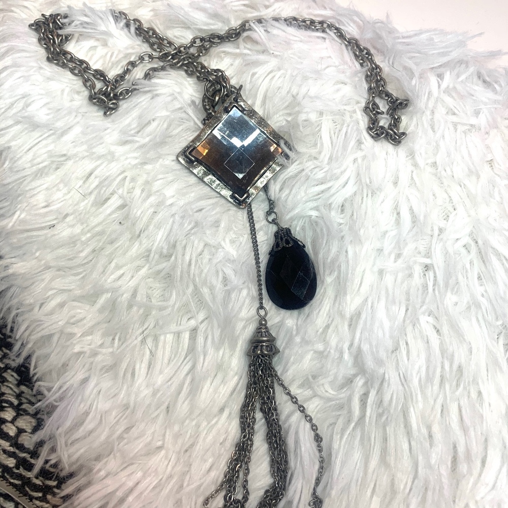 Silver tone chain with charms and metal tassel